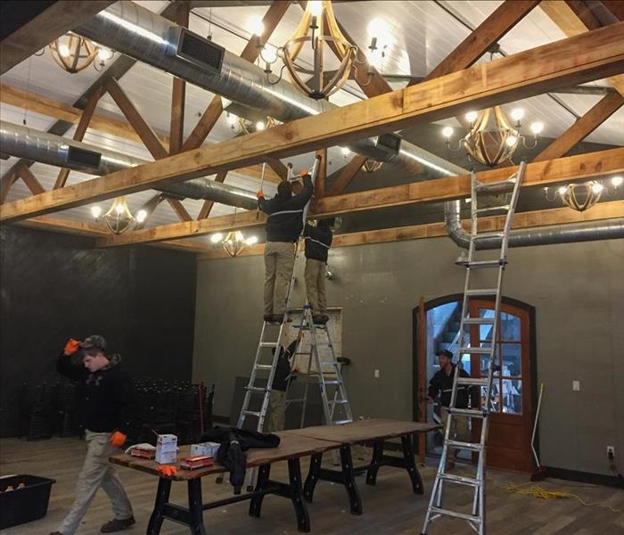 SERVPRO technicians fixing a water leak in the ceiling of a Forest Hills restaurant